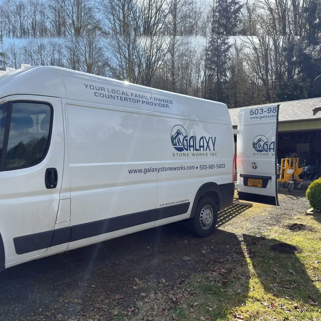 White Galaxy Stone Works delivery vans parked on-site during a custom countertop installation project in Woodland, Washington